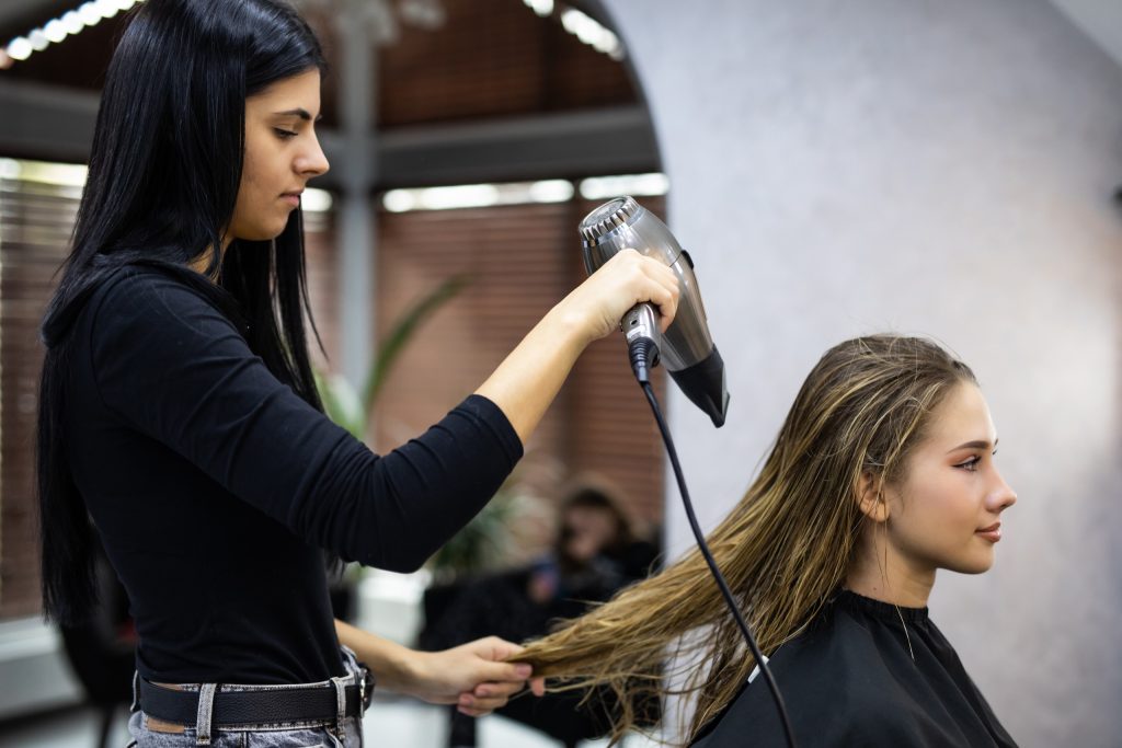 Woman blow drying hair