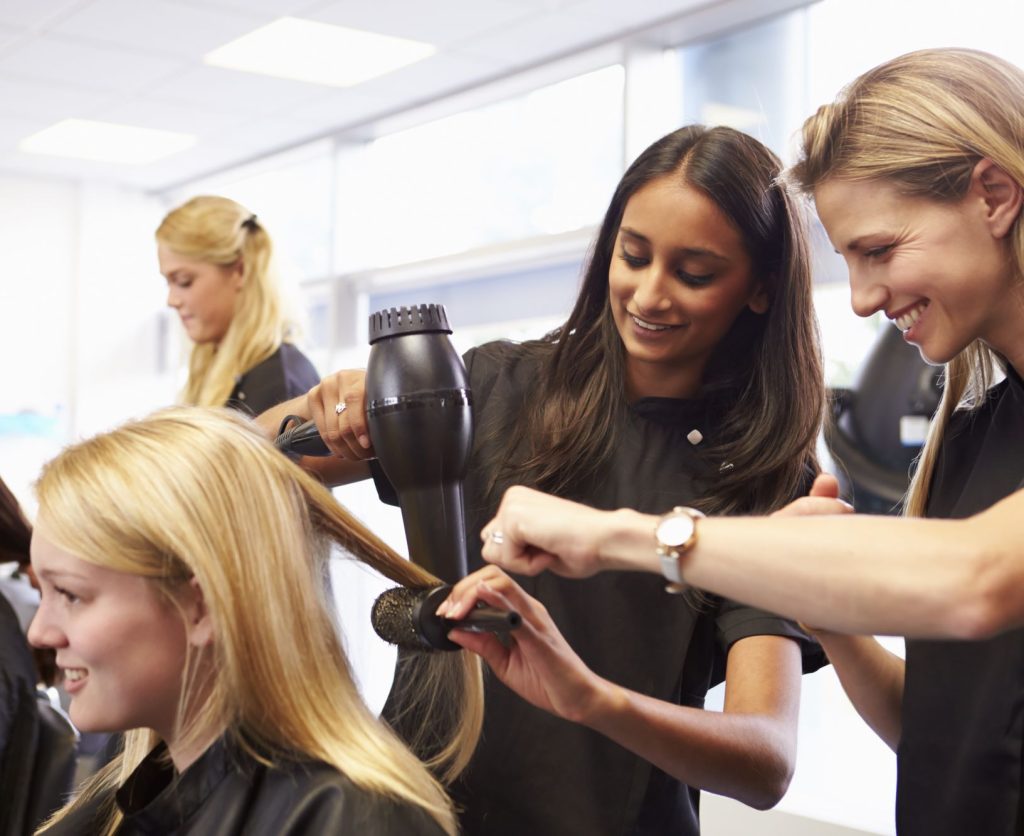 Two people working on a haircut