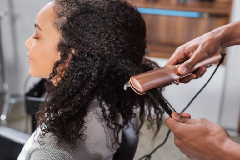 Woman having her hair straightened